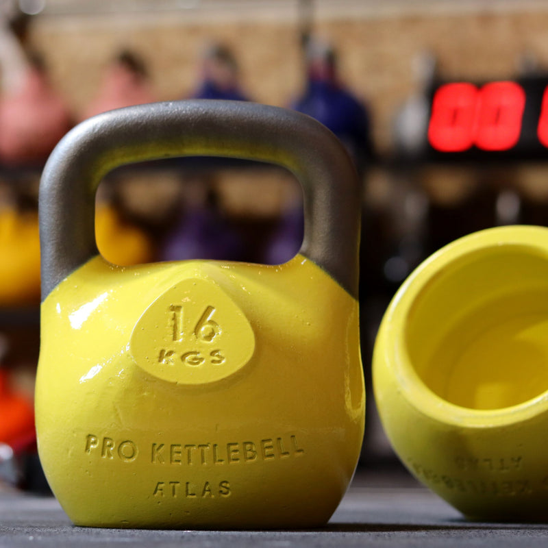 Load image into Gallery viewer, Yellow kettlebells in gym setting