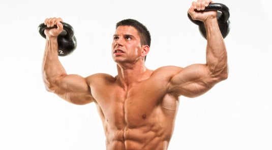 muscular man holding kettlebells