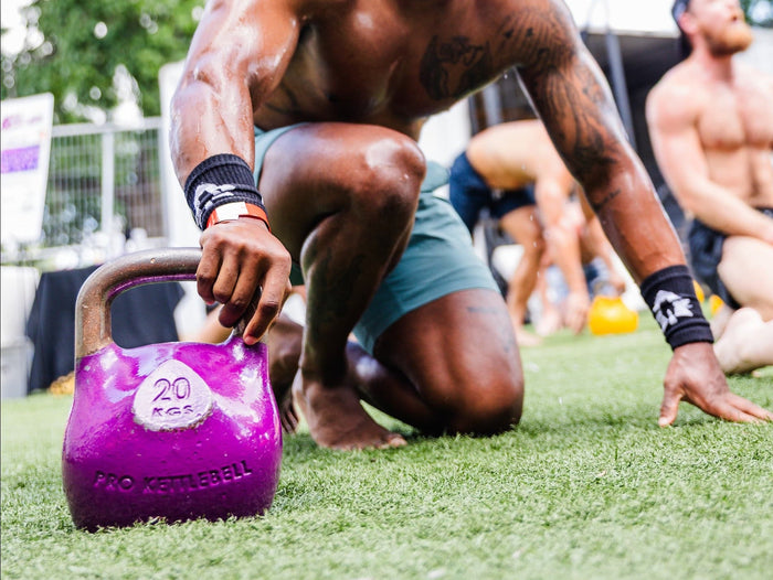 man outside with purple kettlebell