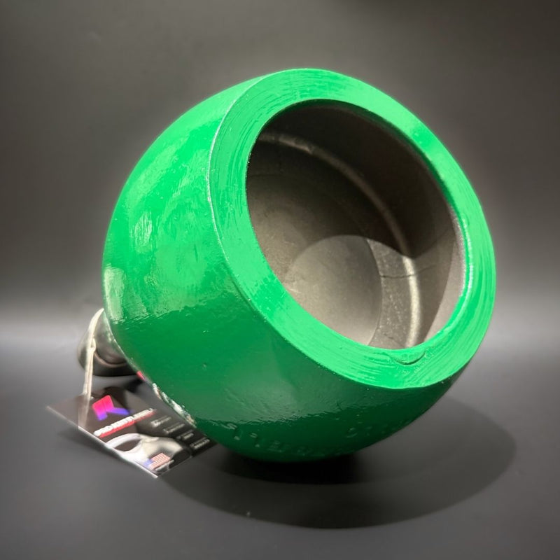 Load image into Gallery viewer, A bright green kettlebell with a wide open tbottom, photographed on a dark gray studio background. A small attached tag is visible near the base.
